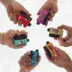 6 hands holding different e-cigarettes